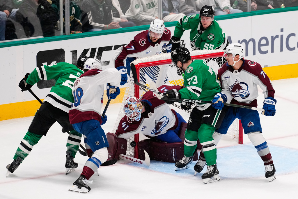 Colorado Avalanche goaltender Scott Wedgewood (41) reaches down to block a shot under pressure from Dallas Stars right wing Arttu Hyry, left, and Adam Erne (73) in the third period of an NHL hockey game Saturday, April 4, 2026, in Dallas. (AP Photo/Tony Gutierrez)