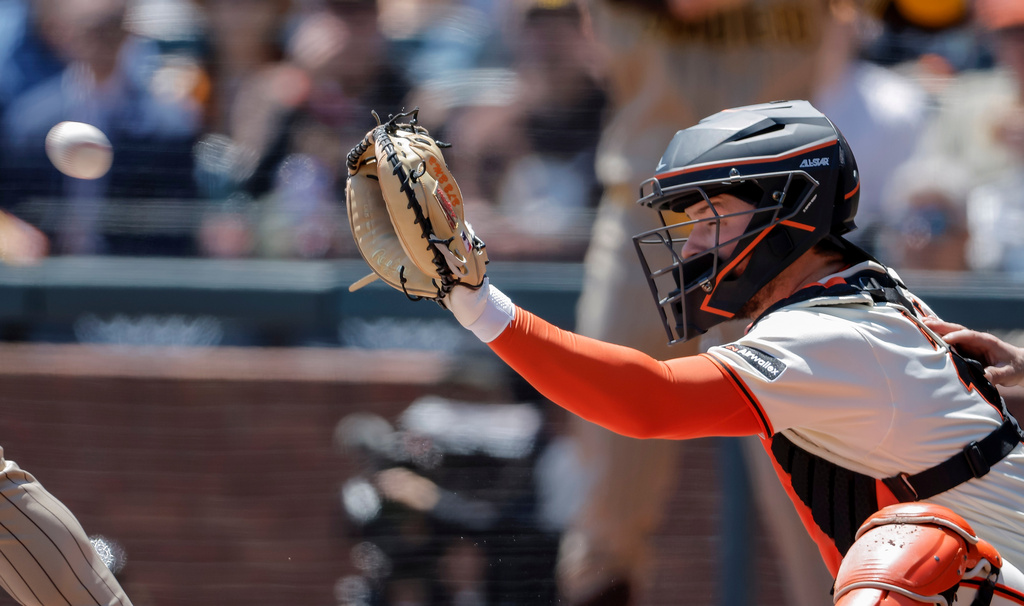 San Francisco Giants' Patrick Bailey (14) receives a pitch from San Francisco Giants' Adrian Houser (12) in the first inning of an MLB game against the San Diego Padres at Oracle Park in San Francisco on Wednesday, May 6, 2026. (Carlos Avila Gonzalez/San Francisco Chronicle via AP)