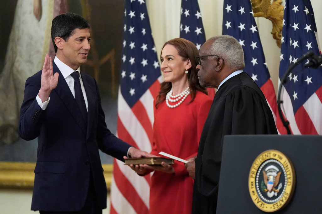 Supreme Court Justice Clarence Thomas administers the oath during the swearing in of Kevin Warsh, left, as Chairman of the Federal Reserve in the East Room of the White House, Friday, May 22, 2026, in Washington, as Warsh's wife Jane Lauder, looks on. (AP Photo/Manuel Balce Ceneta)