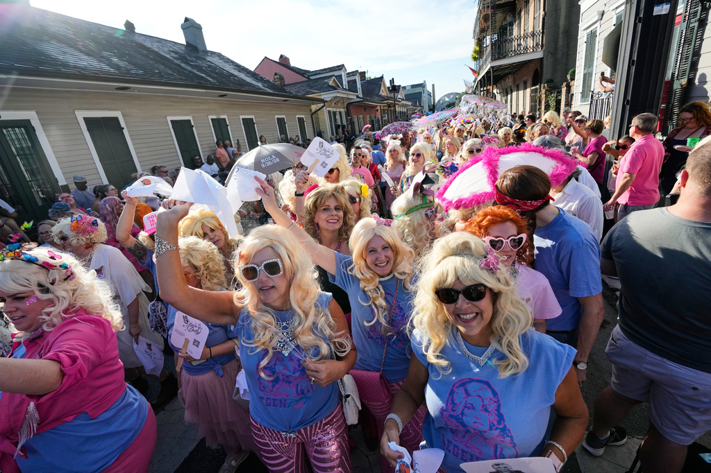 Members of the Krewe of Dolly lead a second line parade in commemoration of the life of Dolly Parton through the French Quarter Friday, Sept. 25, 2026, in New Orleans. (AP Photo/Gerald Herbert)