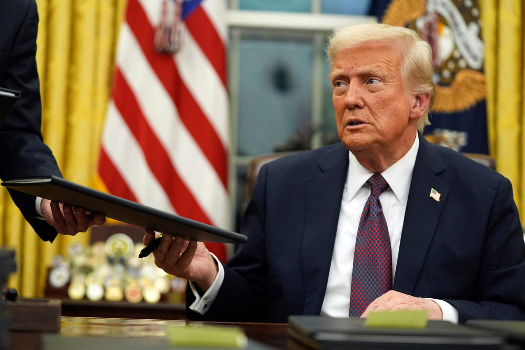FILE - President Donald Trump signs executive orders in the Oval Office of the White House, Jan. 20, 2025, in Washington. (AP Photo/Evan Vucci, File)