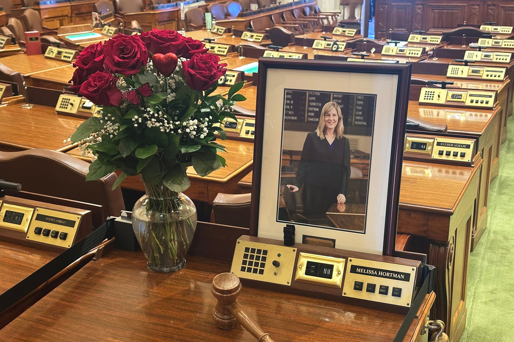 Former Minnesota House Speaker Melissa Hortman's desk sits empty in memoriam except for flowers, her portrait and a gavel in the Minnesota House chamber Wednesday, March 18, 2026, at the State Capitol in St. Paul, Minn. (AP Photo/Steve Karnowski)