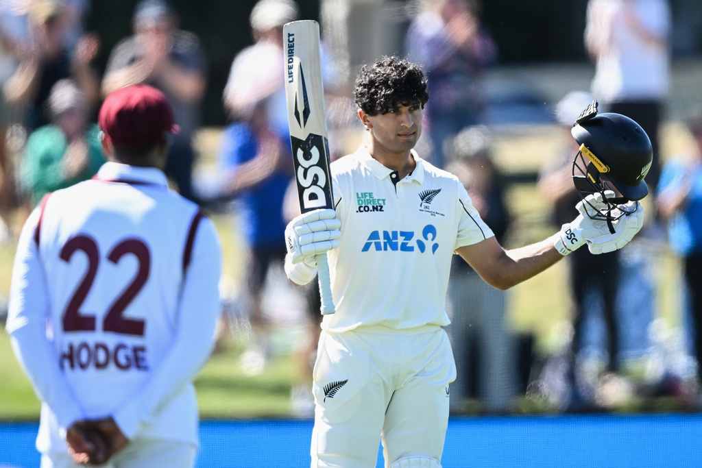 New Zealand's Rachin Ravindra celebrates after making 100 runs against the West Indies on day 3 during their cricket test match in Christchurch, New Zealand, Thursday, Dec. 4, 2025. (Andrew Cornaga/Photosport via AP)