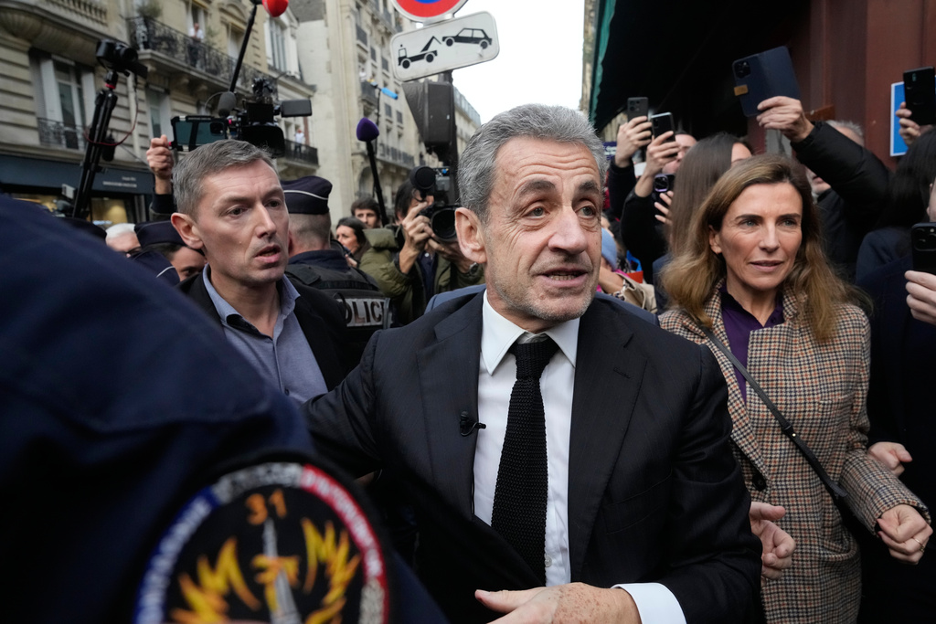Former French President Nicolas Sarkozy arrives to sign his book "Diary of a Prisoner," in a Paris bookshop, Wednesday, Dec. 10, 2025. (AP Photo/Michel Euler)