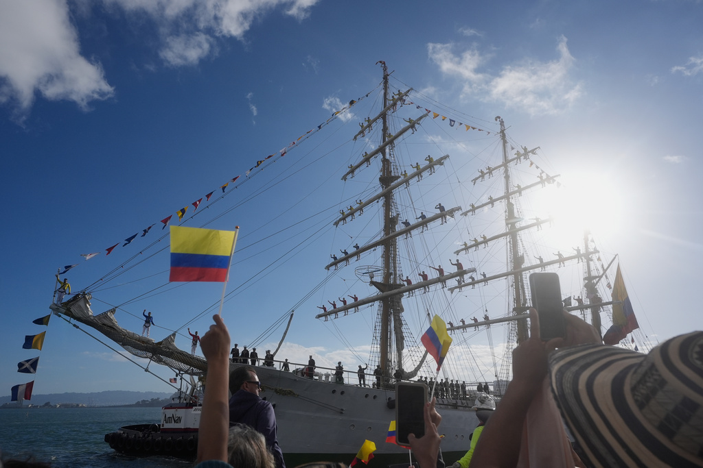 People celebrate as the ARC Gloria, a Colombian tall ship, arrives for Fleet Week in San Francisco, Thursday, Oct. 9, 2025. (AP Photo/Jeff Chiu)