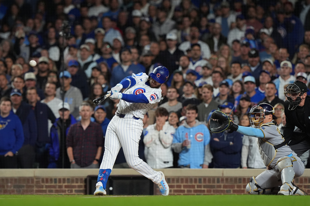 Chicago Cubs' Ian Happ (8) hits a 3-run home run during the first inning of Game 4 of baseball's National League Division Series against the Milwaukee Brewers Thursday, Oct. 9, 2025, in Chicago. (AP Photo/Nam Y. Huh)