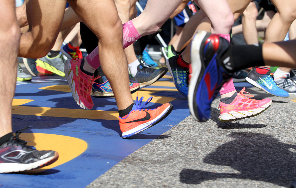 FILE - A colorful collection of shoes cross the starting line at the start of the 2017 Boston Marathon in Hopkinton, Mass., Monday, April 17, 2017. (AP Photo/Mary Schwalm, file)