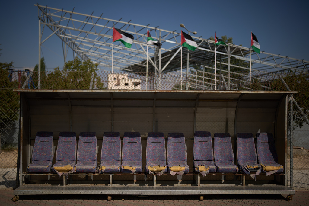 A referees' bench with torn seats is seen next to the field at Dura International Stadium in the West Bank town of Dura, near Hebron, Monday, May 25, 2026. (AP Photo/Leo Correa)