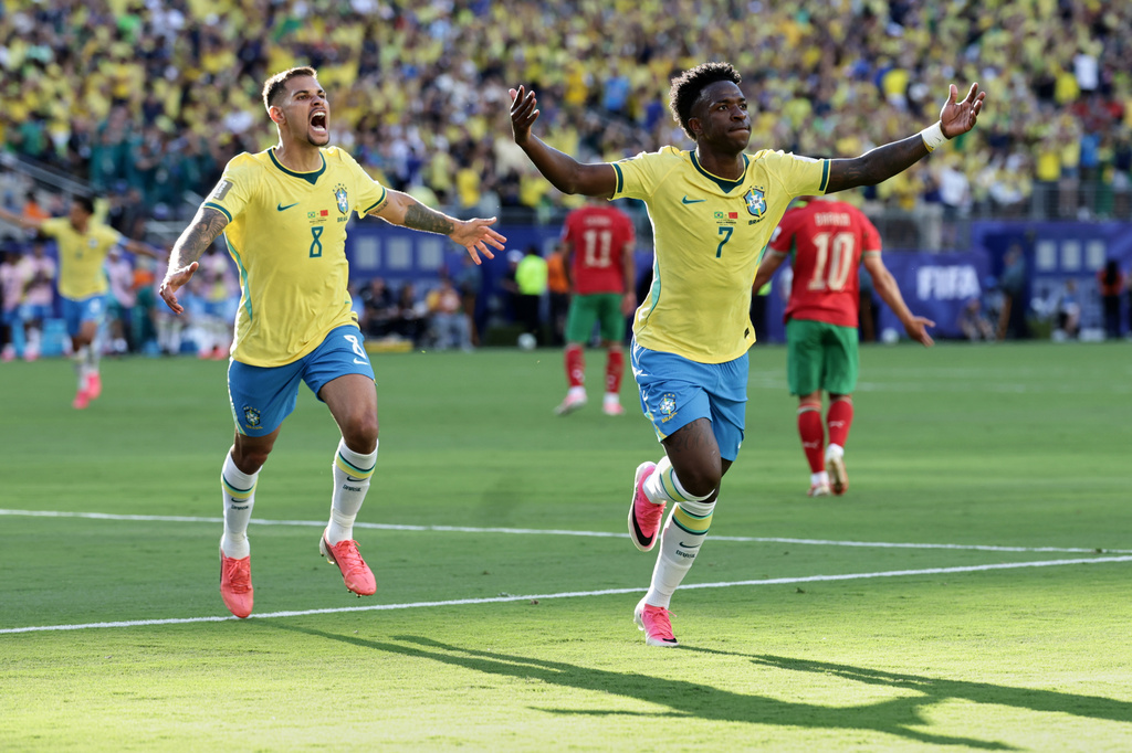 Brazil's Vinicius Junior (7) celebrates after scoring as teammate Bruno Guimaraes (8) watches during the World Cup Group C soccer match against Morocco in East Rutherford, N.J., near New York, Saturday, June 13, 2026. (AP Photo/Matt Slocum)