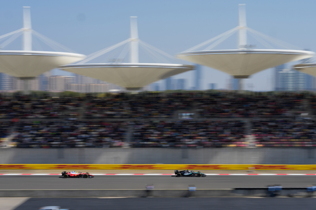 Mercedes driver George Russell, right, of Britain leads Ferrari driver Lewis Hamilton of Britain during the Sprint Race of the Chinese Formula One Grand Prix at the Shanghai International Circuit, in Shanghai, China, Saturday, March 14, 2026. (AP Photo/Vincent Thian)