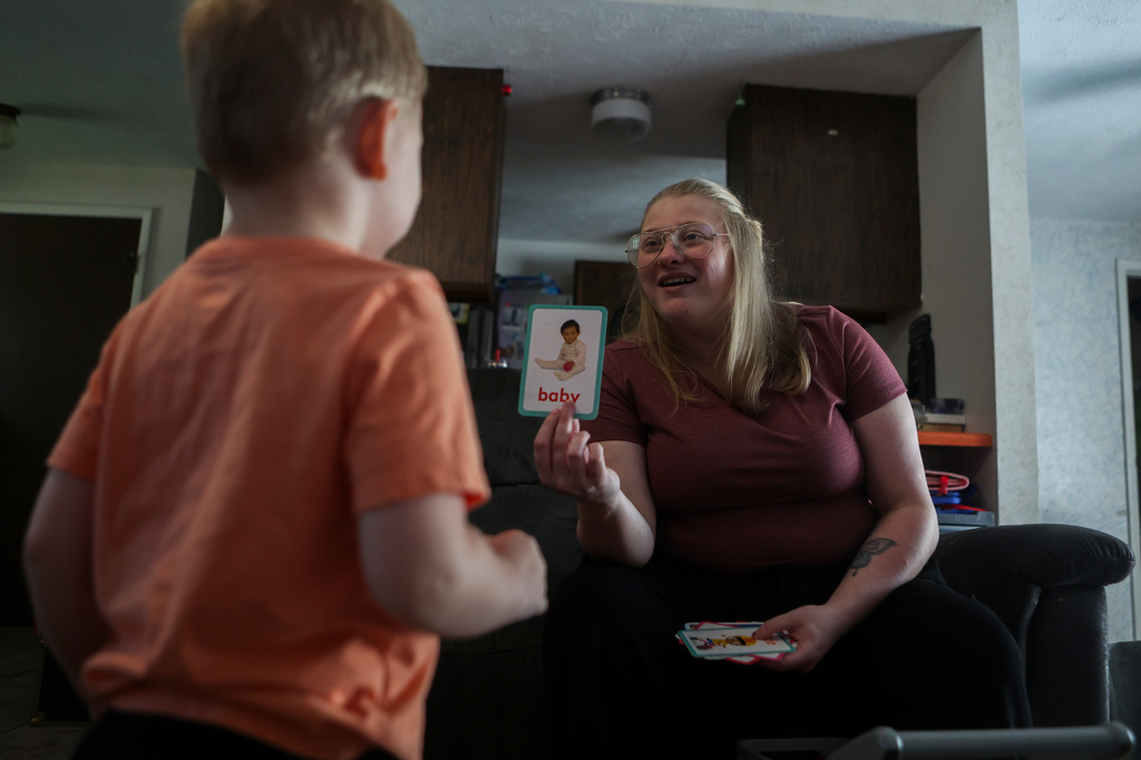 Meygan Maloney goes through flashcards with her son Callum Wilson, 3, Friday, Aug. 28, 2026, at their home in Hartford City, Ind. (AP Photo/Cara Penquite)