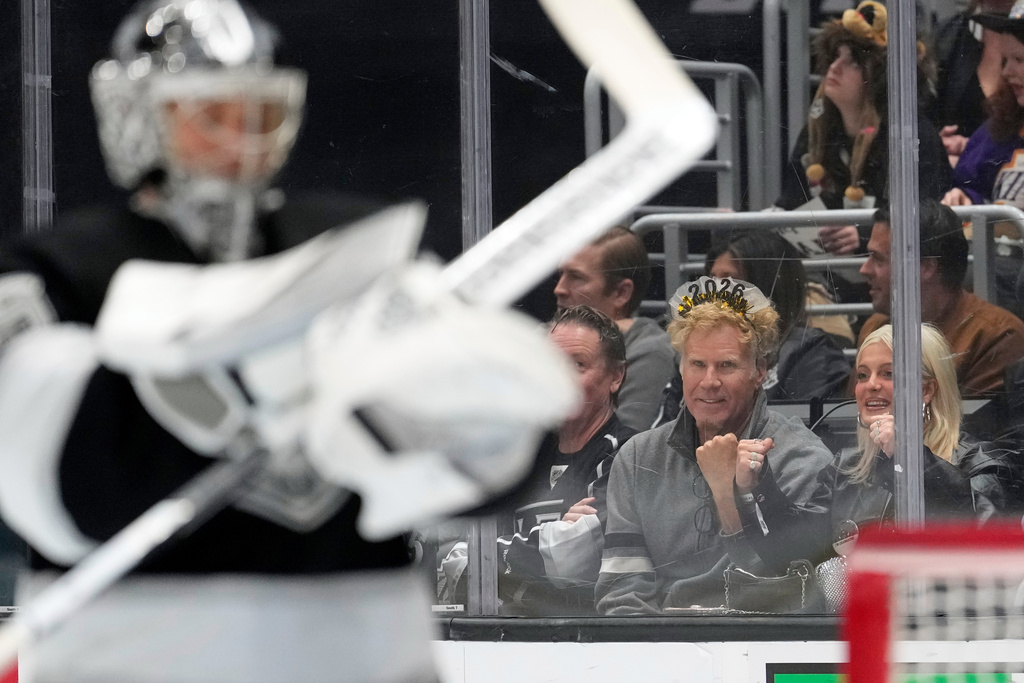 Actor Will Ferrell, center, watches as Los Angeles Kings goaltender Darcy Kuemper stands in goal during the first period of an NHL hockey game against the San Jose Sharks, Wednesday, Jan. 7, 2026, in Los Angeles. (AP Photo/Mark J. Terrill)