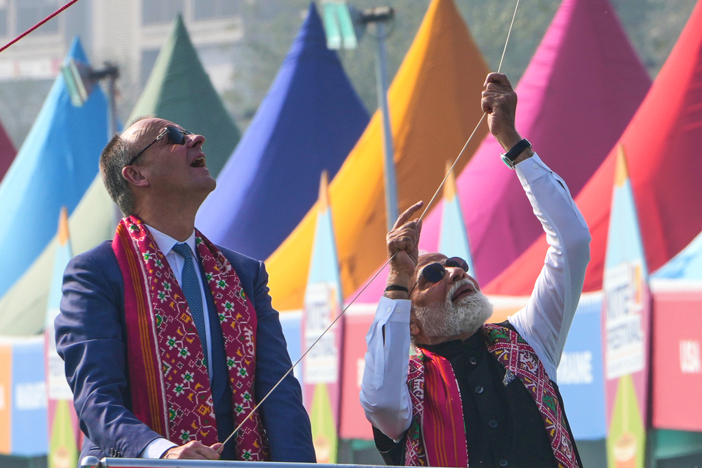 German Chancellor Friedrich Merz, left, and Indian Prime Minister Narendra Modi fly a kite during the inauguration of International kite festival in Ahmedabad, India, Monday, Jan. 12, 2026. (AP Photo/Ajit Solanki)