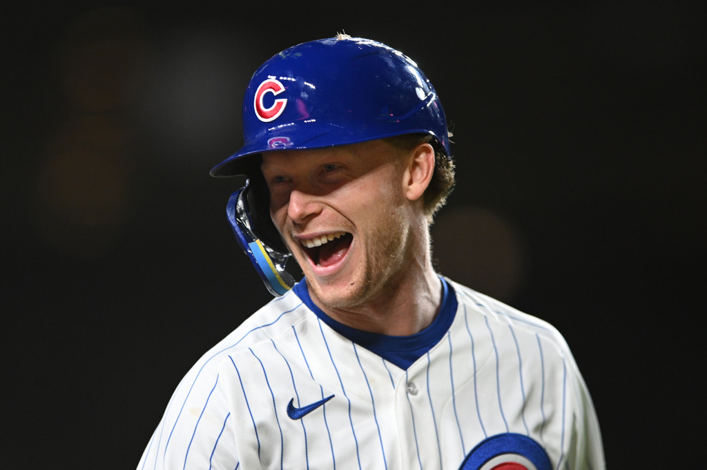 Chicago Cubs' Pete Crow-Armstrong jokes with Miami Marlins players in the dugout during the sixth inning of a baseball game Tuesday, Sept. 22, 2026, in Chicago. (AP Photo/Paul Beaty)