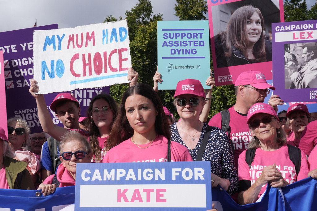 Campaigners gather to protest in support of assisted dying, in Parliament Square, central London, Friday Sept. 11, 2026. (Stefan Rousseau/PA via AP)