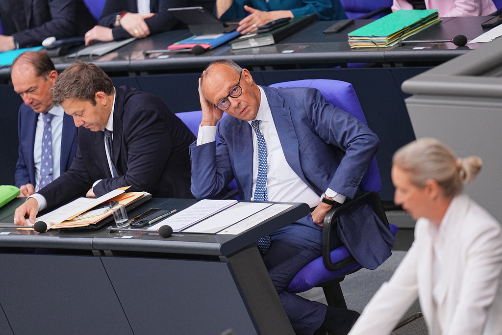 German Chancellor Friedrich Merz looks at federal chairwoman and parliamentary group leader of the AfD Alice Weidel as she opens the general debate as part of the budget deliberations in the Bundestag, in Berlin, Wednesday Sept. 9, 2026 (Michael Kappeler/dpa via AP)