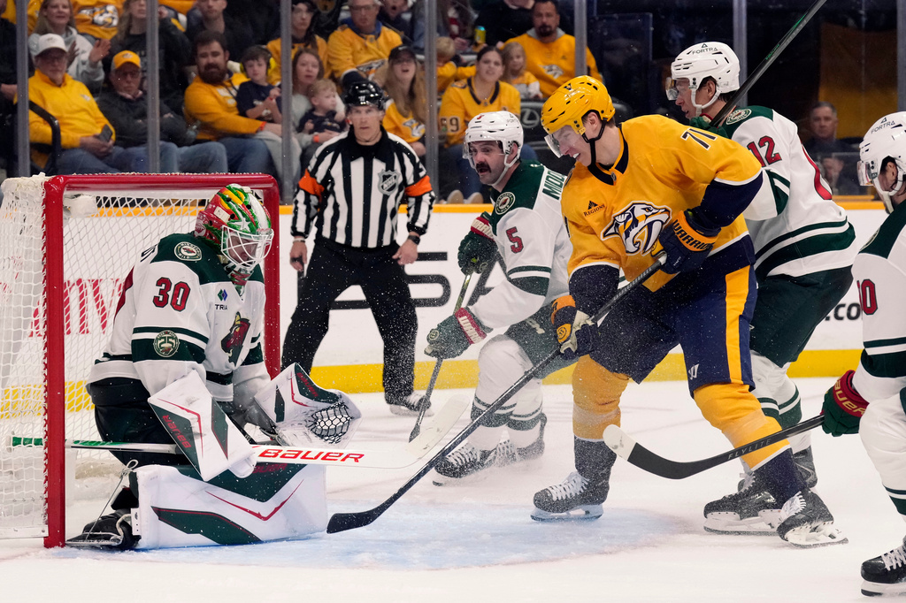 Minnesota Wild goaltender Jesper Wallstedt (30) blocks a shot by Nashville Predators right wing Matthew Wood (71) during the second period of an NHL hockey game Saturday, April 11, 2026, in Nashville, Tenn. (AP Photo/Mark Humphrey)