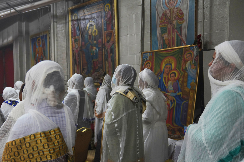FILE - Congregants wear netela, a white scarf-like cotton cloth that signifies modesty and purity, during a service at Re'ese Adbarat Debre Selam Kidist Mariam Church, an Ethiopian Orthodox Tewahedo church, in Washington, on Saturday, April 5, 2025. (AP Photo/Jessie Wardarski, File)