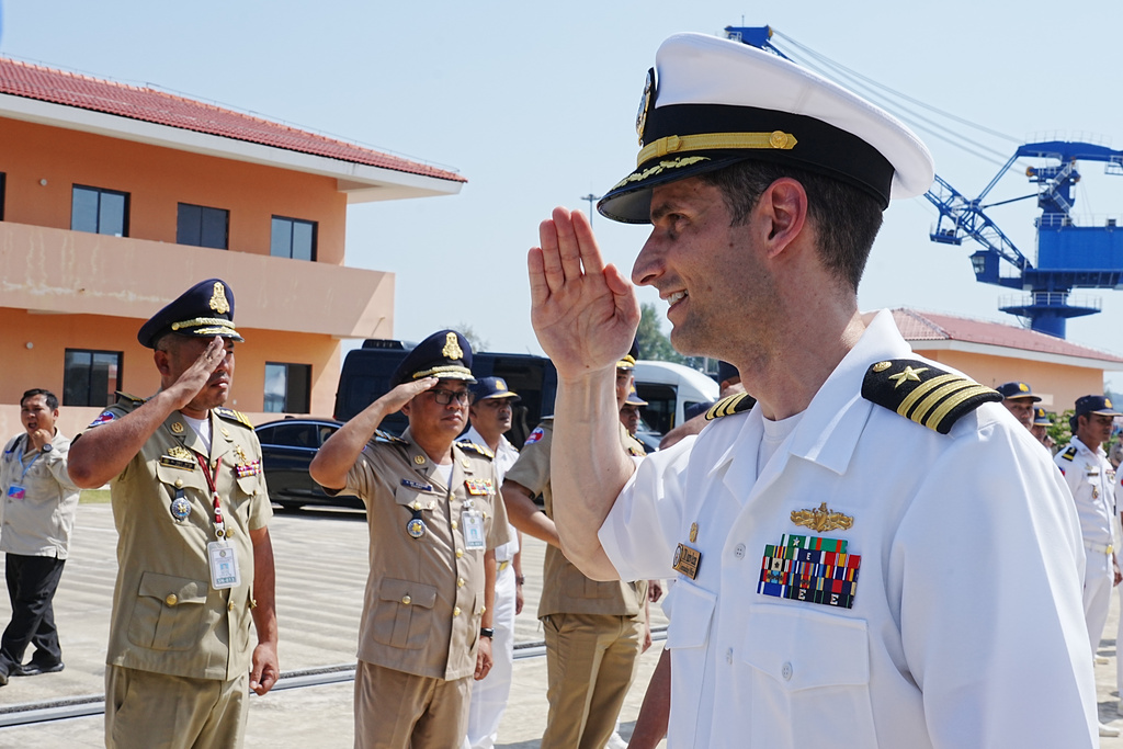 Captain of USS Cincinnati Andrew Recame, right, salutes Cambodian naval members as they welcome the U.S. warship at Ream Naval Base's pier in Sihanoukville Cambodia, Saturday, Jan. 24, 2026. (AP Photo/Heng Sinith)