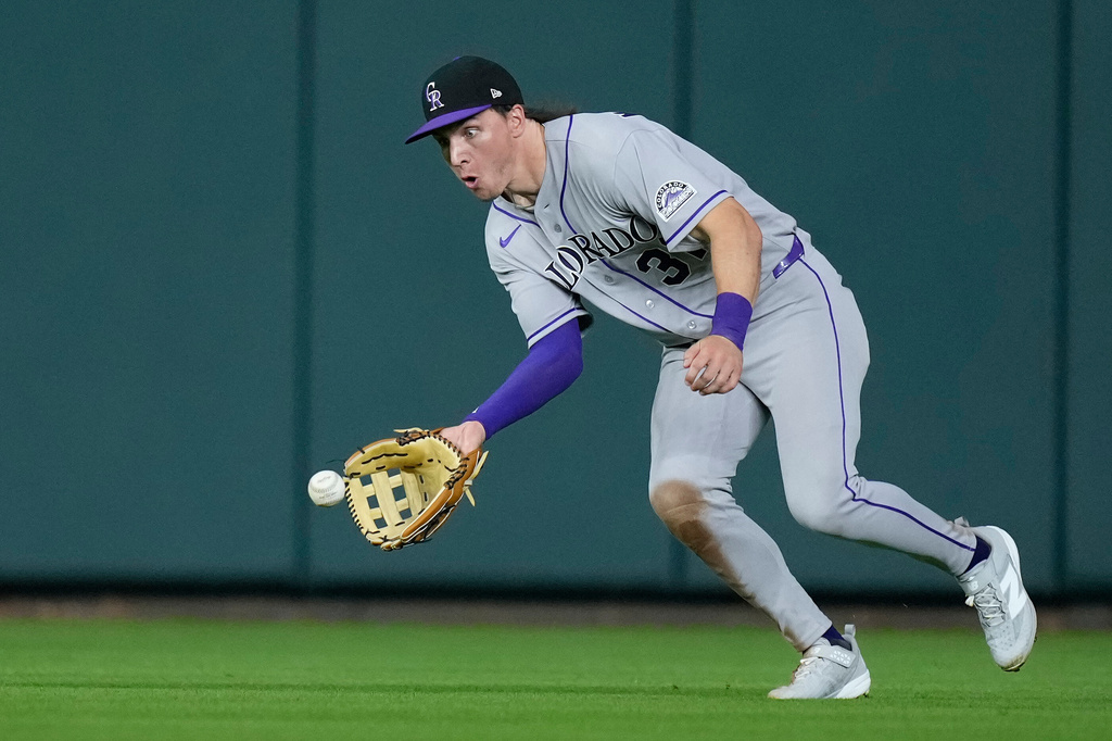 Colorado Rockies center fielder Jake McCarthy (31) fields a single by Houston Astros' Christian Walker during the seventh inning of a baseball game Tuesday, April 14, 2026, in Houston. (AP Photo/Kevin M. Cox)