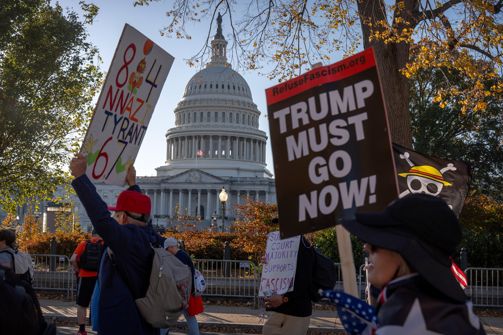 Demonstrators opposed to President Donald Trump protest near the Capitol on Wednesday, Nov. 5, 2025, in Washington. (AP Photo/Mark Schiefelbein)