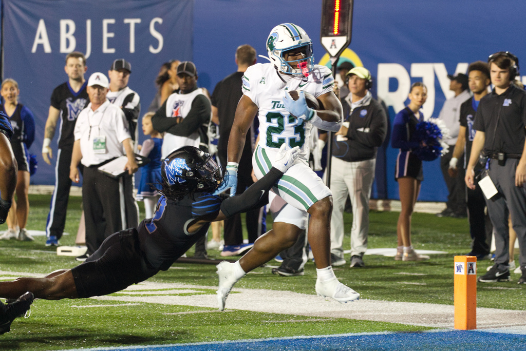 Tulane running back Javin Gordon (23) steps into the end zone to score a touchdown against Memphis during the first half of an NCAA college football game, Friday, Nov. 7, 2025, in Memphis, Tenn. (AP Photo/Nikki Boertman)