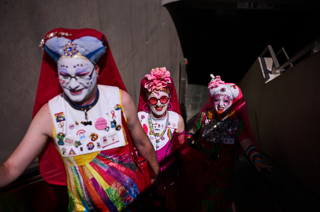 From left, Sister Pia, Sister Clementia and Sister Daphne of the German chapter OSPI of the Sisters of Perpetual Indulgence, SPI, arrive at a train station for the first Berlin Drag March on the eve of the Pride March in Berlin, Germany, Friday, July 24, 2026. (AP Photo/Markus Schreiber)