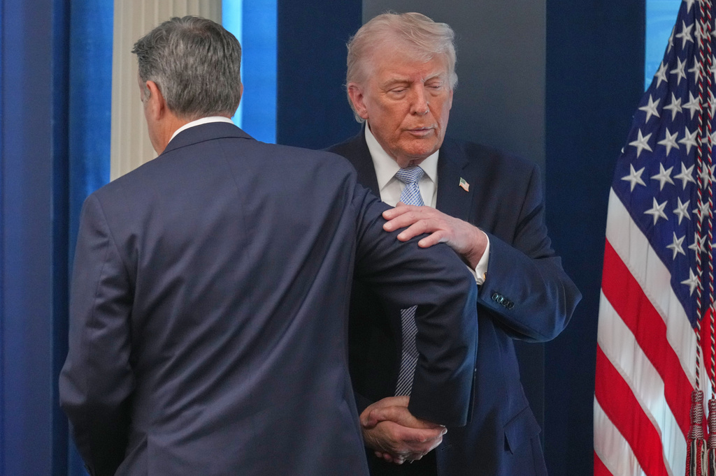 President Donald Trump shakes hands with CIA Director John Ratcliffe as they speak with reporters in the James Brady Press Briefing Room at the White House, Monday, April 6, 2026, in Washington. (AP Photo/Mark Schiefelbein)