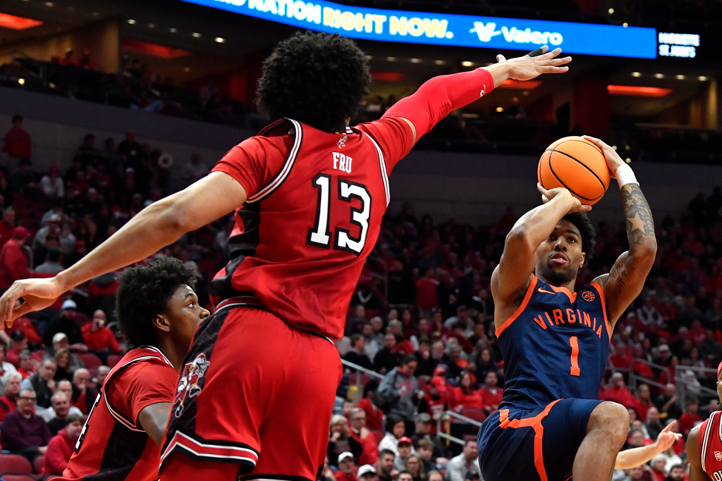 Virginia guard Malik Thomas (1) attempts a shot over Louisville forward Sananda Fru (13) during the first half of an NCAA college basketball game in Louisville, Ky., Tuesday, Jan. 13, 2026. (AP Photo/Timothy D. Easley)