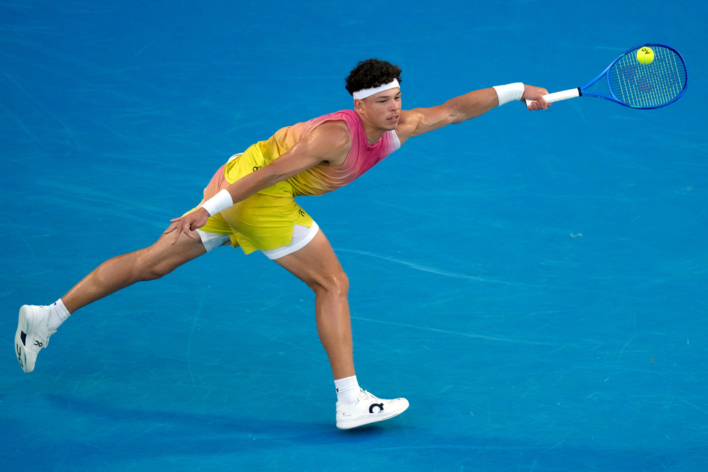 FILE - Ben Shelton of the U.S. plays a forehand return to Jannik Sinner of Italy during their semifinal match at the Australian Open tennis championship in Melbourne, Australia, Jan. 24, 2025. (AP Photo/Manish Swarup, File)