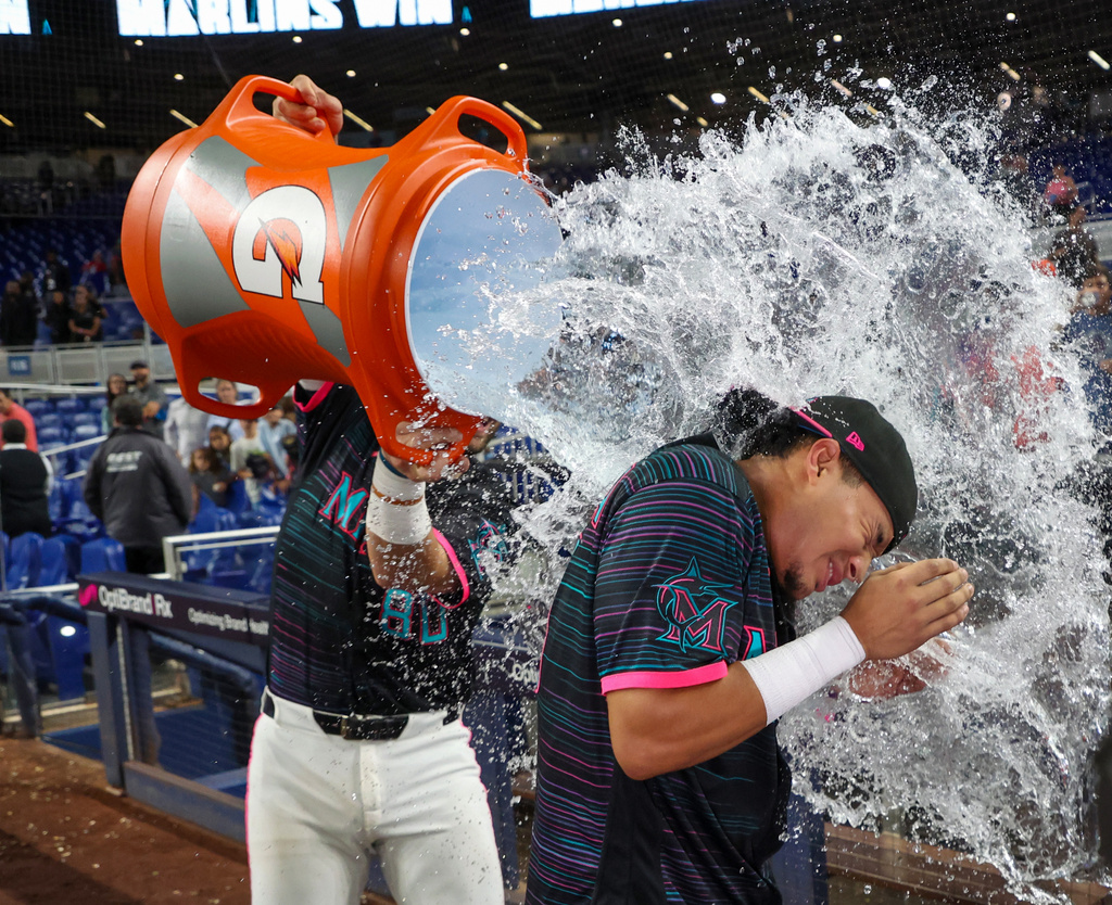 Miami Marlins' Javier Sanoja gets doused with a water cooler by teammate Joe Mack after hitting a game-winning RBI single during the ninth inning of a baseball game against the Washington Nationals, Friday, Aug. 21, 2026, in Miami. (AP Photo/David Santiago)