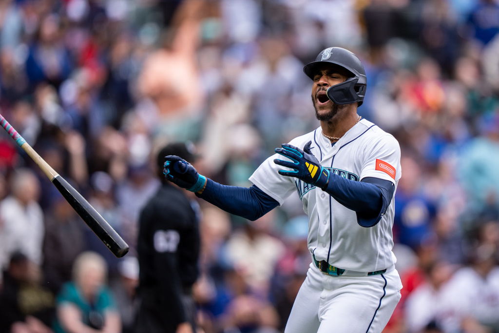 Seattle Mariners' Julio Rodríguez tosses his bat and celebrates after hitting a solo home run during the sixth inning of a baseball game against the Atlanta Braves, Wednesday, May 6, 2026, in Seattle. (AP Photo/Stephen Brashear)