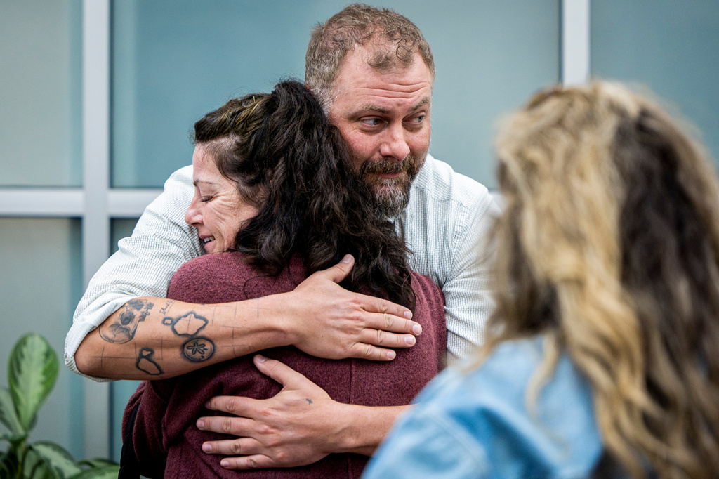 Utah County Sheriff's Deputy Jake Hall, lead detective on the case, looks to other family members as he hugs Tommi Aime, youngest sister of Laura Ann Aime, after announcing that definitive evidence has linked Ted Bundy to Laura's murder at a news conference at the Utah County Sheriff's Office, in Spanish Fork, Utah, Wednesday, April 1, 2026. (Isaac Hale/The Deseret News via AP)