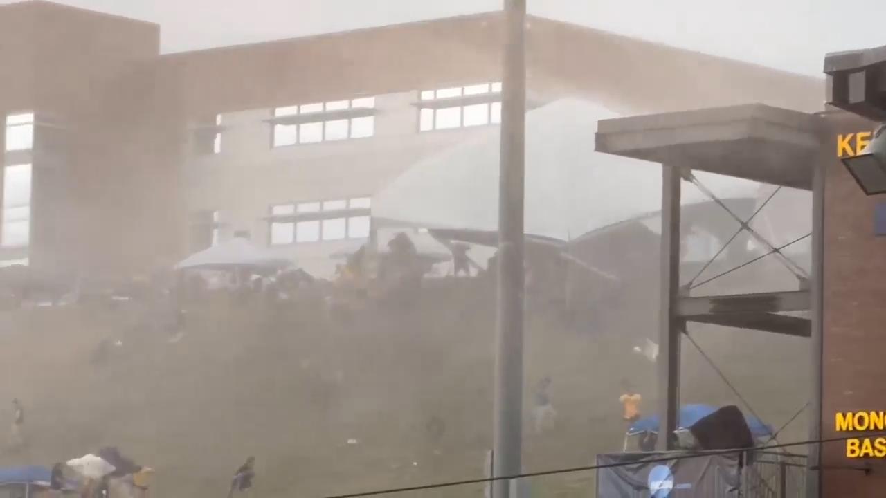 Strong wind at NCAA baseball tournament in West Virginia sends 5 people to the hospital