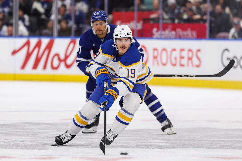 Buffalo Sabres' Peyton Krebs (19) carries the puck down ice during the first period of an NHL hockey game against the Toronto Maple Leafs in Toronto, Saturday, Oct. 25, 2025. (Nick Iwanyshyn/The Canadian Press via AP)