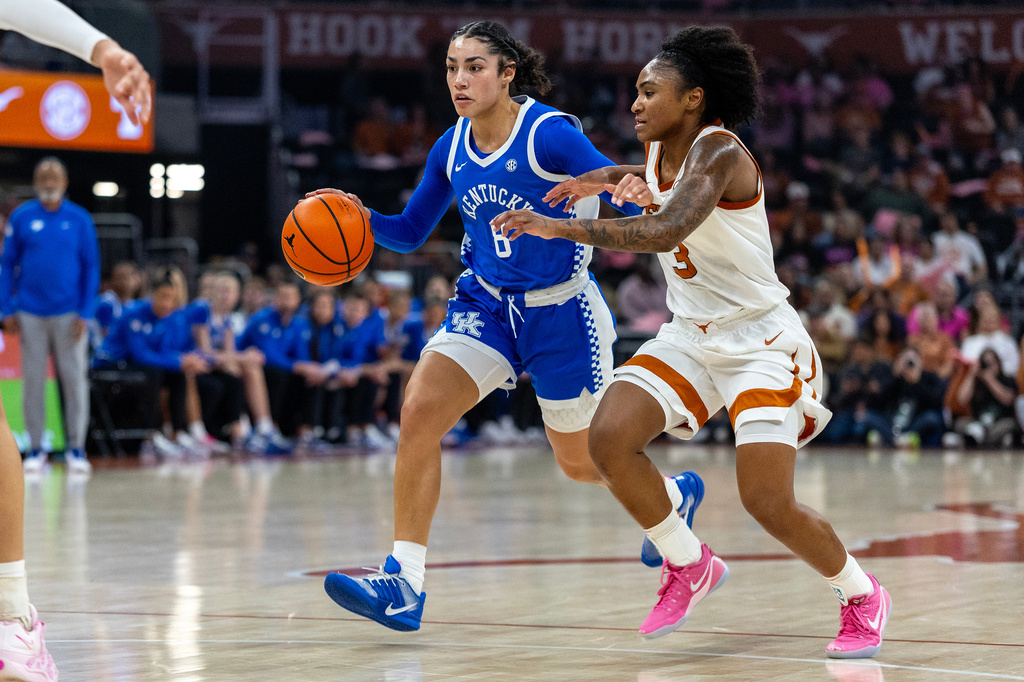 Kentucky guard Asia Boone (8) drives the court with Texas guard Rori Harmon (3) during the first half of an NCAA college basketball game, Monday, Feb. 9, 2026, in Austin, Texas. (AP Photo/Stephen Spillman)