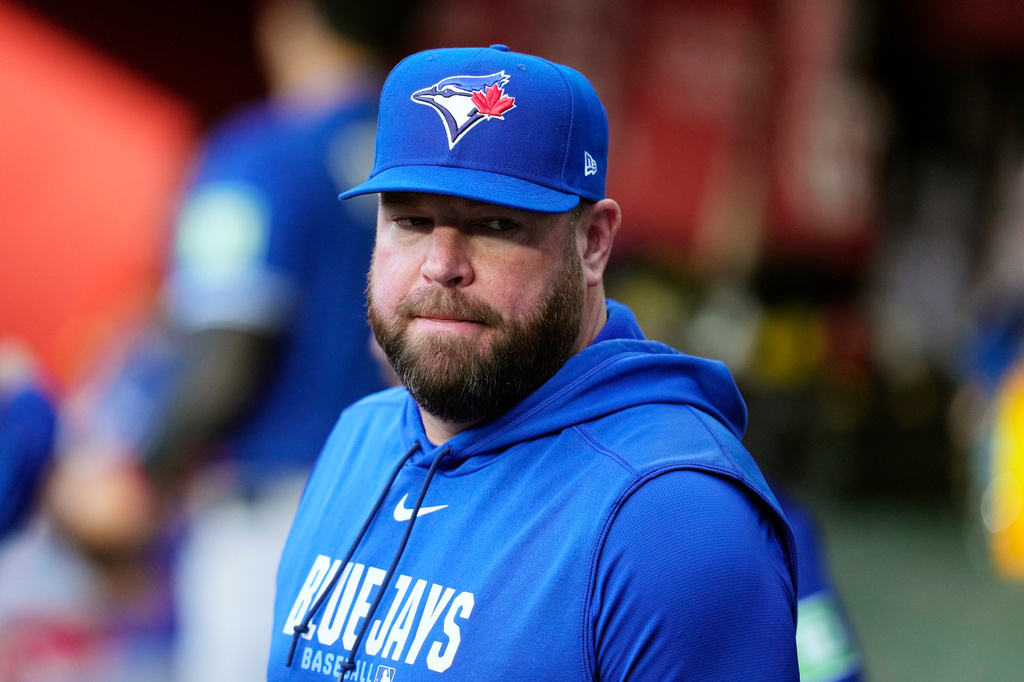 Toronto Blue Jays manager John Schneider pauses in the team dugout prior to a baseball game against the Arizona Diamondbacks, Saturday, April 18, 2026, in Phoenix. (AP Photo/Ross D. Franklin)
