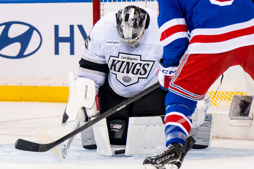 Los Angeles Kings goaltender Darcy Kuemper, left, makes a save during the first period of an NHL hockey game against the New York Rangers, Monday, March 16, 2026, in New York. (AP Photo/Angelina Katsanis)