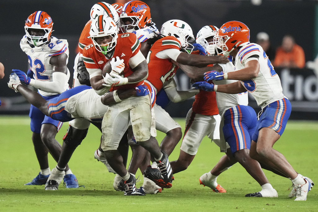 Miami running back CharMar Brown (6) runs for a first down during the second half of an NCAA college football game against Florida, Saturday, Sept. 20, 2025, in Miami Gardens, Fla. (AP Photo/Lynne Sladky)