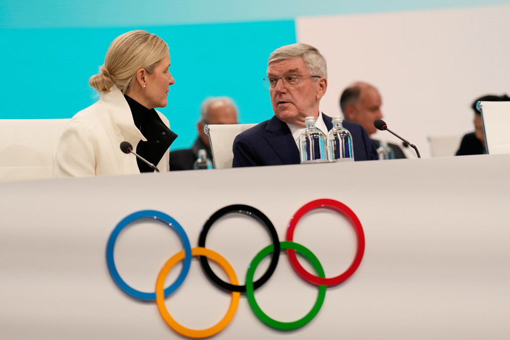 IOC President Kirsty Coventry speaks with former IOC president Thomas Bach, during the opening of the IOC Session, ahead of the 2026 Winter Olympics, in Milan, Italy, Tuesday, Feb. 3, 2026. (AP Photo/Luca Bruno)