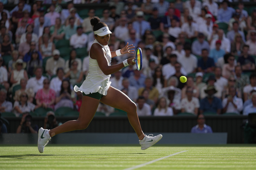 Naomi Osaka of Japan returns the ball to Aryna Sabalenka of Belarus in their fourth round women's singles match at the Wimbledon Tennis Championships in London, Sunday, July 5, 2026. (AP Photo/Brian Inganga)
