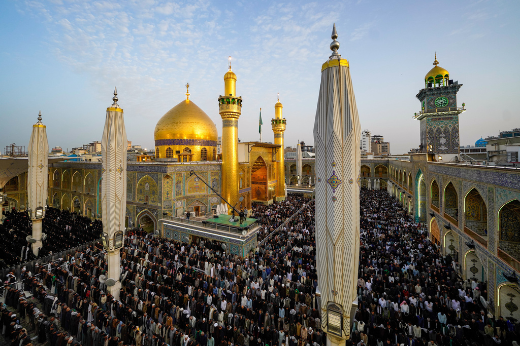 Iraqi Shiite Muslims gather for an Eid al-Fitr prayer at the shrine of Imam Ali shrine in Najaf, Saturday, March 21, 2026. The Eid al-Fitr holiday marks the end of the holy fasting month of Ramadan. (AP Photo/Anmar Khalil)