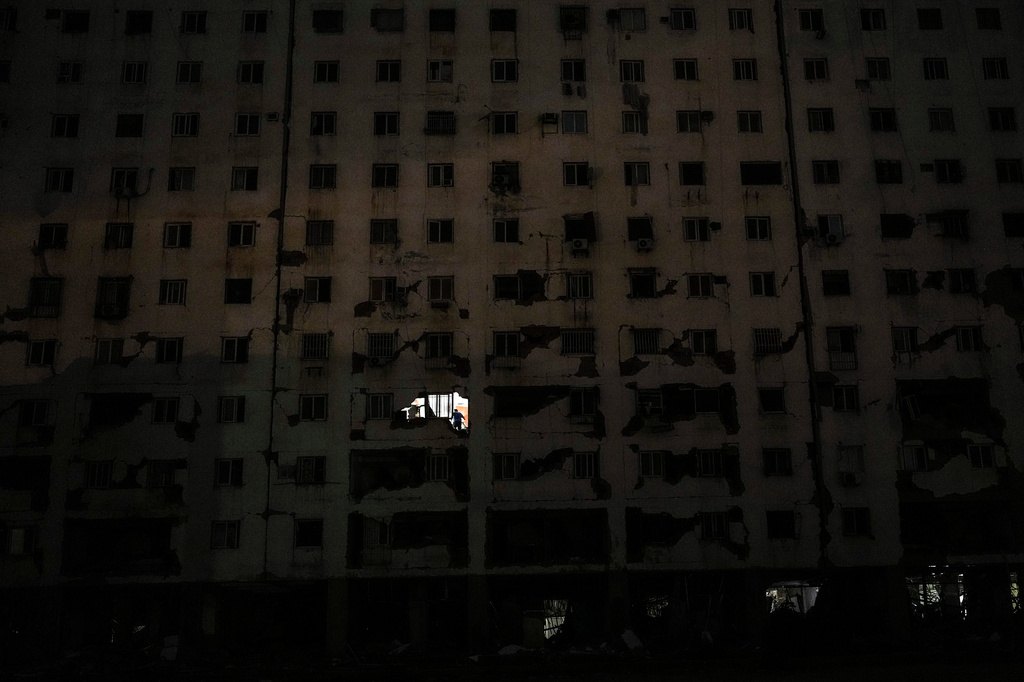 A person stands in an apartment of a damaged building two days after an earthquake struck La Guaira, Venezuela, Friday, June 26, 2026. (AP Photo/Matias Delacroix)