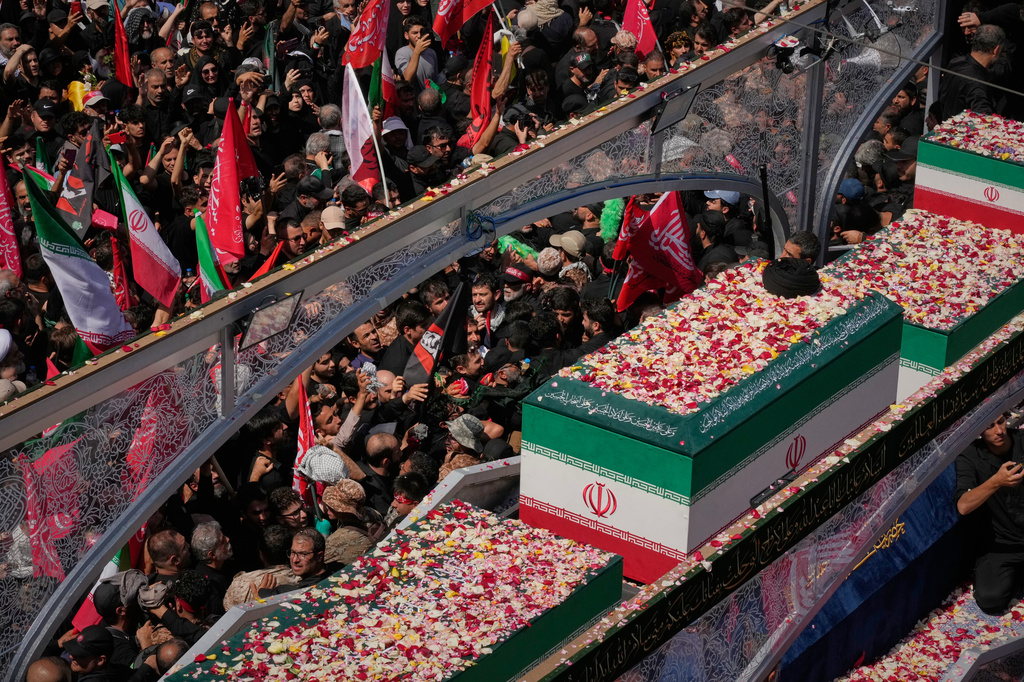 Mourners surround a truck carrying the coffins of the slain Iranian Supreme Leader Ayatollah Ali Khamenei and members of his family during the funeral procession in Tehran, Iran, Monday, July 6, 2026. (AP Photo/Vahid Salemi)