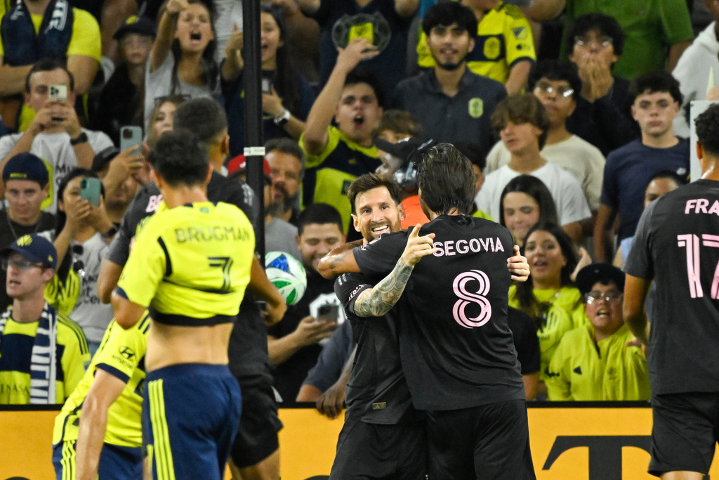 Inter Miami forward Lionel Messi celebrates with midfielder Telasco Segovia (8) after scoring against Nashville SC during the second half of a MLS soccer match Saturday, Oct. 28, 2025, in Nashville, Tenn. (AP Photo/John Amis)