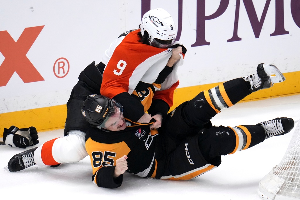 Pittsburgh Penguins' Avery Hayes (85) and Philadelphia Flyers' Jamie Drysdale (9) fight during the first period of an NHL hockey game in Pittsburgh, Saturday, March 7, 2026. (AP Photo/Gene J. Puskar)