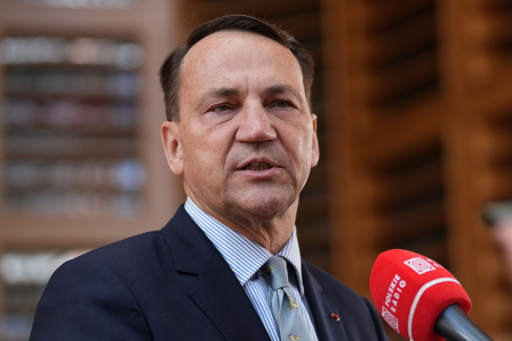 Poland's Foreign Minister Radoslaw Sikorski speaks with the media as he arrives for a meeting of EU foreign ministers in Brussels, Monday, July 13, 2026. (AP Photo/Marius Burgelman)