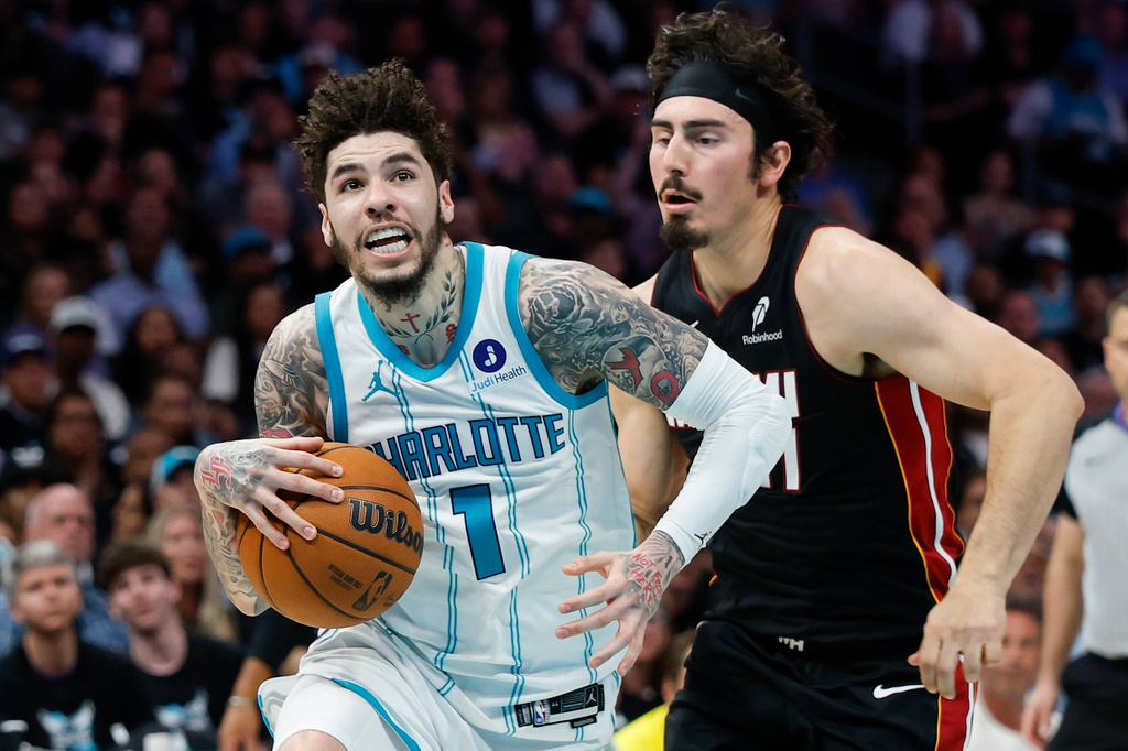 Charlotte Hornets guard LaMelo Ball (1) drives to the basket against Miami Heat forward Jaime Jaquez Jr. during the first half of an NBA play-in tournament basketball game in Charlotte, N.C., Tuesday, April 14, 2026. (AP Photo/Nell Redmond)