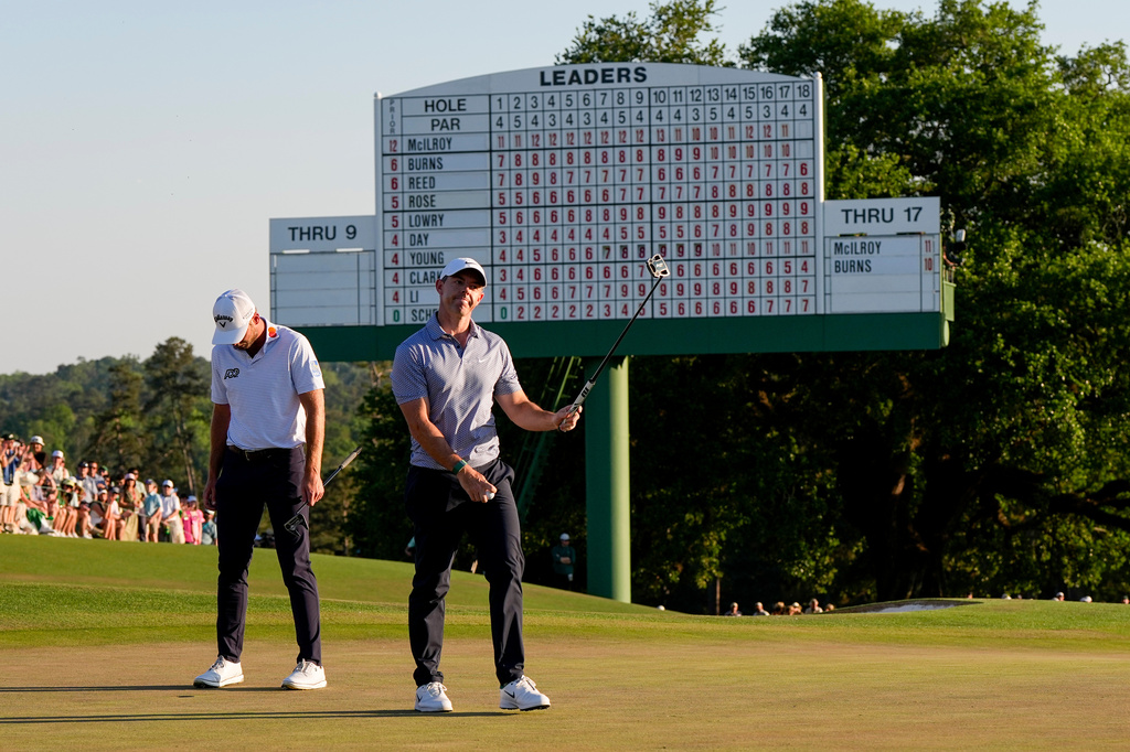 Rory McIlroy, of Northern Ireland, waves after his putt on the 18th hole during the third round of the Masters golf tournament at the Augusta National Golf Club, Saturday, April 11, 2026, in Augusta, Ga. (AP Photo/David J. Phillip)