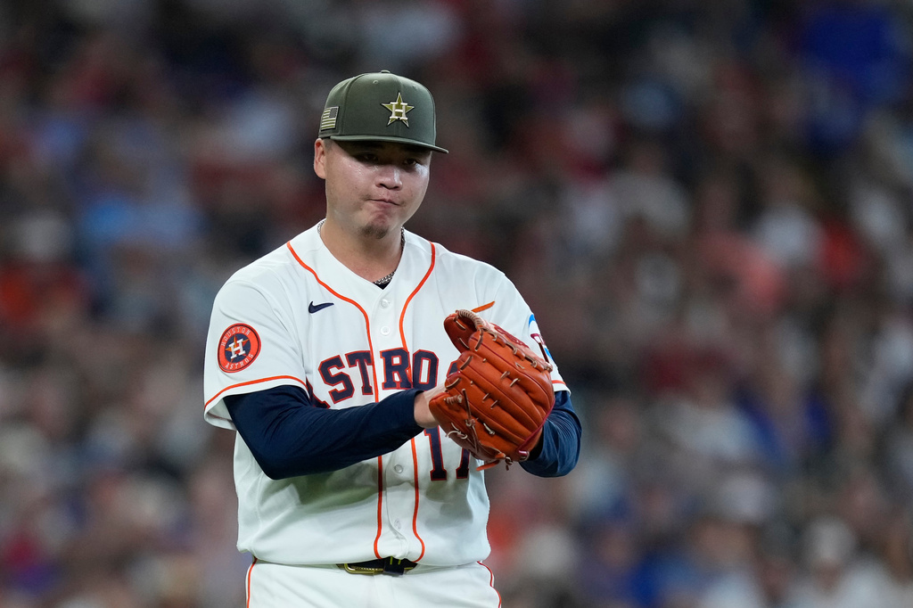 Houston Astros pitcher Kai-Wei Teng claps after getting out of a jam during the fourth inning of a baseball game against the Texas Rangers, Saturday, May 16, 2026, in Houston. (AP Photo/Kevin M. Cox)